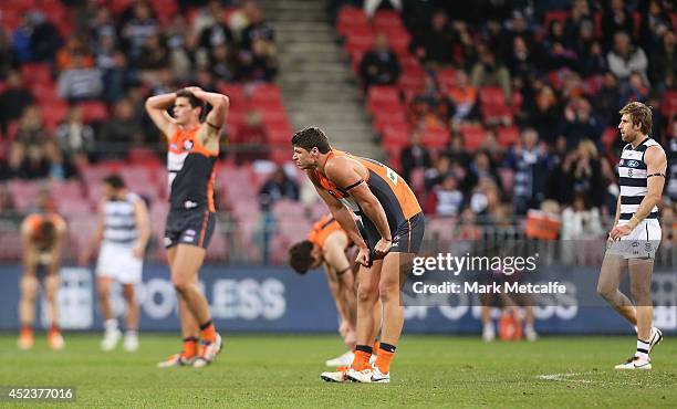 Giants players Tom Boyd, Jonathon Patton and Jeremy Cameron look dejected after defeat in the round 18 AFL match between the Greater Western Sydney...