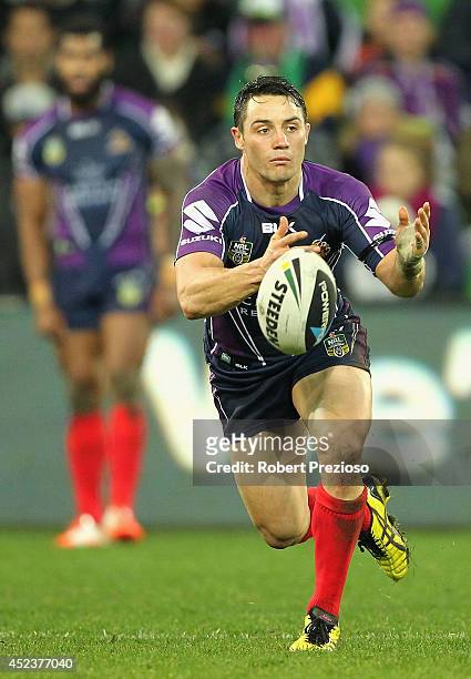 Cooper Cronk of the Storm offloads the ball during the round 19 NRL match between the Melbourne Storm and the Canberra Raiders at AAMI Park on July...