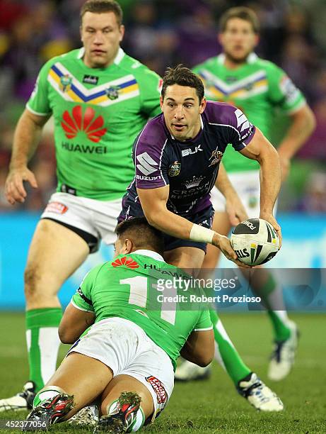 Billy Slater of the Storm looks to offload the ball during the round 19 NRL match between the Melbourne Storm and the Canberra Raiders at AAMI Park...