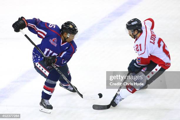 Emerson Etem of the USA and Josh Lunden of Canada compete for the puck during the International Ice Hockey Series match between the USA and Canada at...