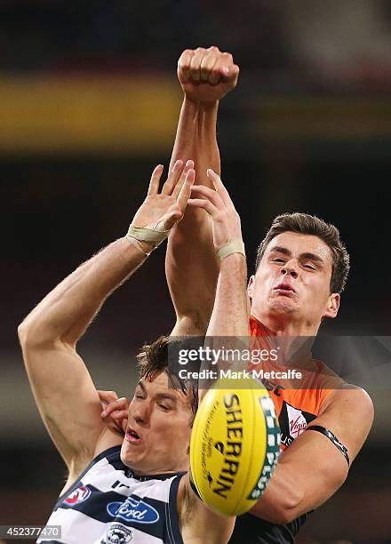 Tom Boyd of the Giants competes for the ball against Andrew Mackie of the Cats during the round 18 AFL match between the Greater Western Sydney...