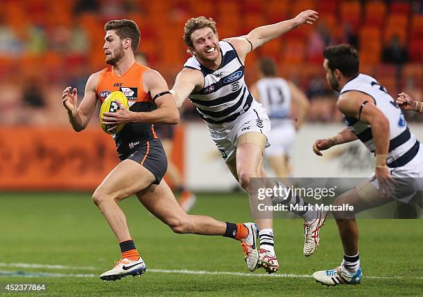 Tomas Bugg of the Giants evades a tackle during the round 18 AFL match between the Greater Western Sydney Giants and the Geelong Cats at Spotless...