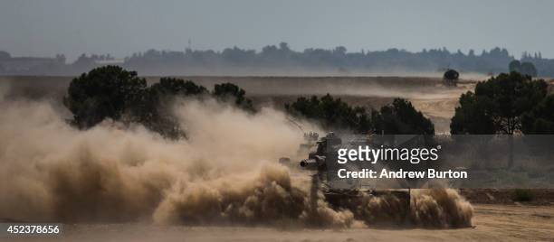 Tank moves positions near the Israeli-Gaza border during an operation on July 19, 2014 near Sderot, Israel. As operation "Protective Edge" enters...