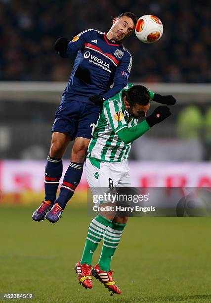 Steed Malbranque of Lyon beats Nono of Real Betis to a header during the UEFA Europa League Group I match between Olympique Lyonnais and Real Betis...