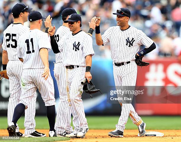 Derek Jeter of the New York Yankees celebrates the win with teammates Brian Roberts,Jacoby Ellsbury,Brett Gardner and Mark Teixeira after the win...