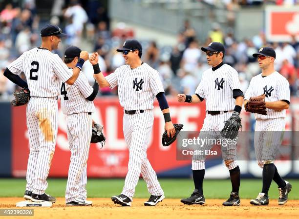 Derek Jeter of the New York Yankees celebrates the win with teammates Jacoby Ellsbury, Brian Roberts,Ichiro Suzuki and Brett Gardner after the win...