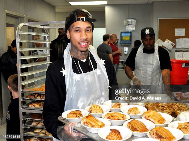 Rap artist Tyga serves Thanksgiving dinner at Union Rescue Mission on November 28, 2013 in Los Angeles, California.