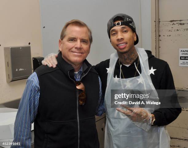 Rap artist Tyga with Union Rescue Mission CEO Andy Bales at the at Union Rescue Mission on November 28, 2013 in Los Angeles, California.