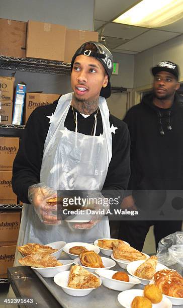 Rap artist Tyga serves Thanksgiving dinner at Union Rescue Mission on November 28, 2013 in Los Angeles, California.