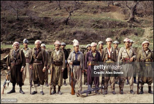 Kurdish Peshmerga fighters sing a patriotic song while on parade in a hidden military camp in the Zagros Mountains of northern Iraq, 10th May 1979.