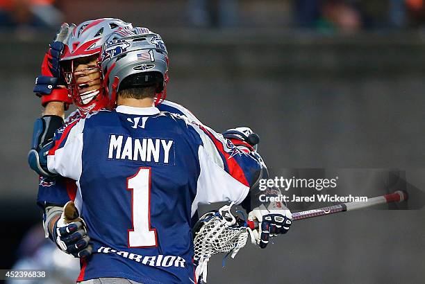 Brent Adams is congratulated by teammate Will Manny of the Boston Cannons after scoring in the second half against the New York Lizards during the...