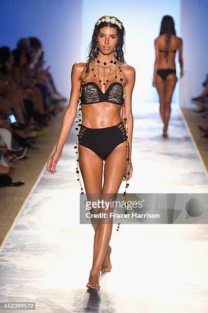 Model walks the runway at the L*Space By Monica Wise fashion show during Mercedes-Benz Fashion Week Swim 2015 at The Raleigh at Raleigh Hotel on July...