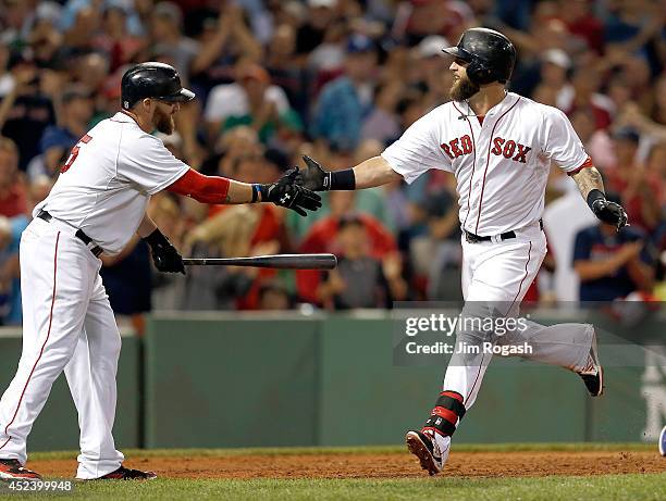 Mike Napoli of the Boston Red Sox celebrates with Jonny Gomes of the Boston Red Sox after he connected for a home run in the sixth inning against the...