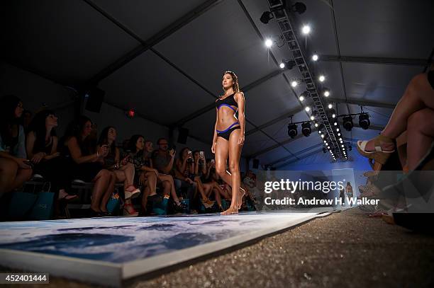 Model walks the runway at the L*Space By Monica Wise fashion show during Mercedes-Benz Fashion Week Swim 2015 at The Raleigh on July 19, 2014 in...