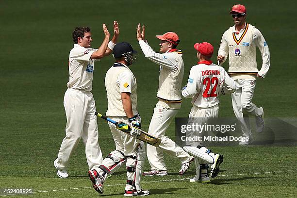 Chadd Sayers and Michael Klinger of the Redbacks celebrates the wicket of Aaron Finch of the Bushrangers during day one of the Sheffield Shield match...