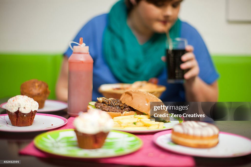 Young woman in cafe with table of food