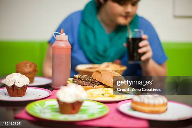 young woman in cafe with table of food - over eating stock pictures, royalty-free photos & images