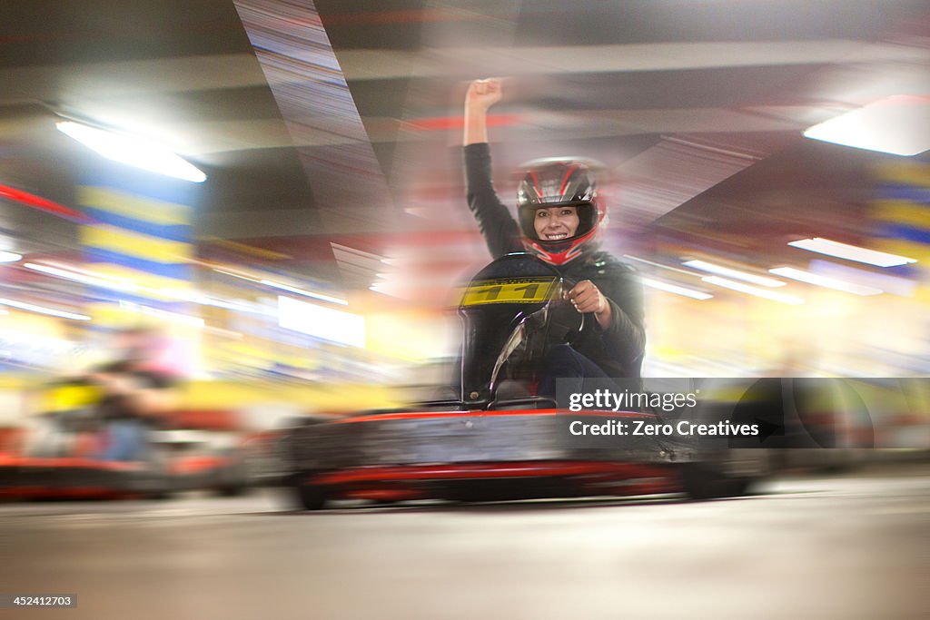 Mid adult woman driving go cart