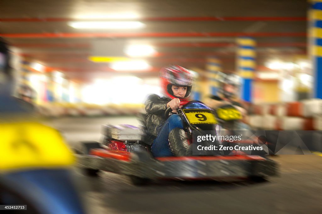 Young woman racing on go cart track