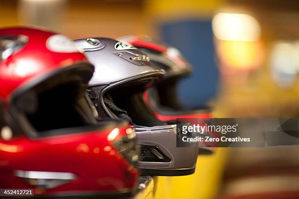 go carting crash helmets in a row - crash helmet fotografías e imágenes de stock