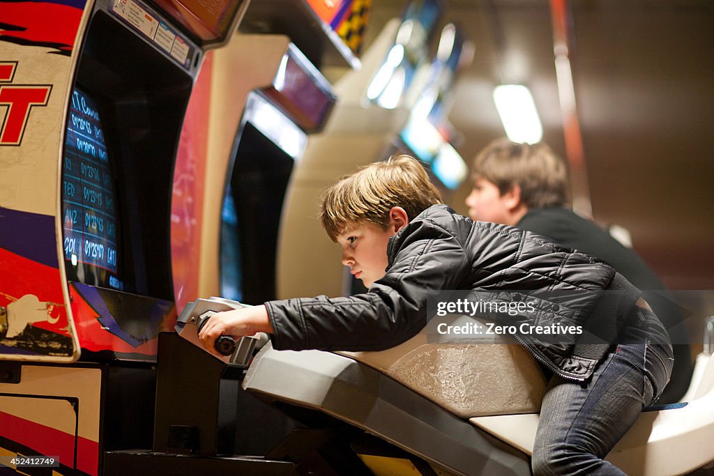 Two young brothers playing on driving video games