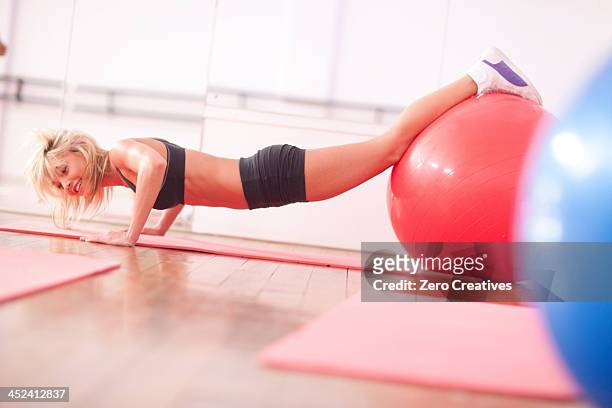 young woman in gym training with exercise balls - woman swimsuit happy normal stock pictures, royalty-free photos & images