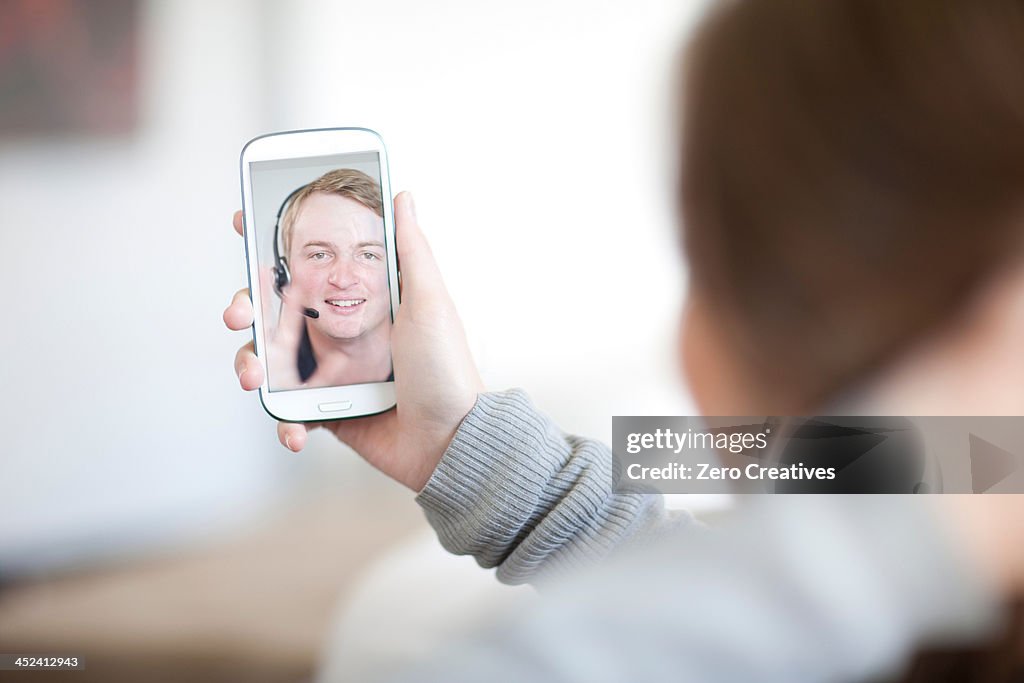 Young woman making video call on cellphone