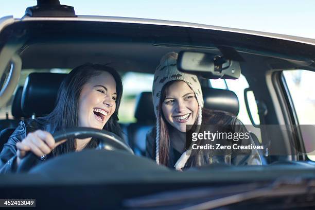 two young women driving car - front view bildbanksfoton och bilder