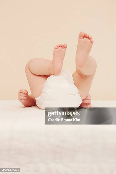 babys bottom in diaper - cute bums stock pictures, royalty-free photos & images