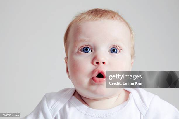 baby girl pouting lip - blue eyes stock pictures, royalty-free photos & images