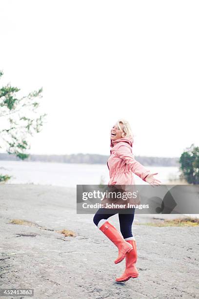 happy woman in rain - stockholm archipelago stock pictures, royalty-free photos & images