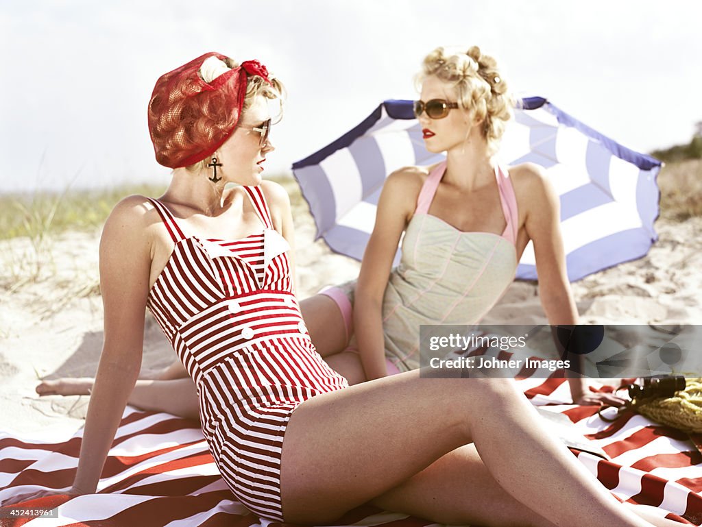 Two retro young women on beach