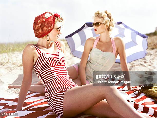 two retro young women on beach - badkläder bildbanksfoton och bilder