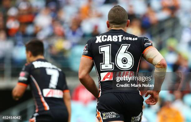 Robbie Farah of the Tigers wears as a tribute to injured Knights player Alex McKinnon during the round 19 NRL match between the Wests Tigers and the...