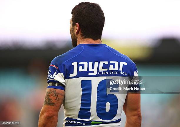 Michael Ennis of the Bulldogs wears as a tribute to injured Knights player Alex McKinnon during the round 19 NRL match between the Wests Tigers and...