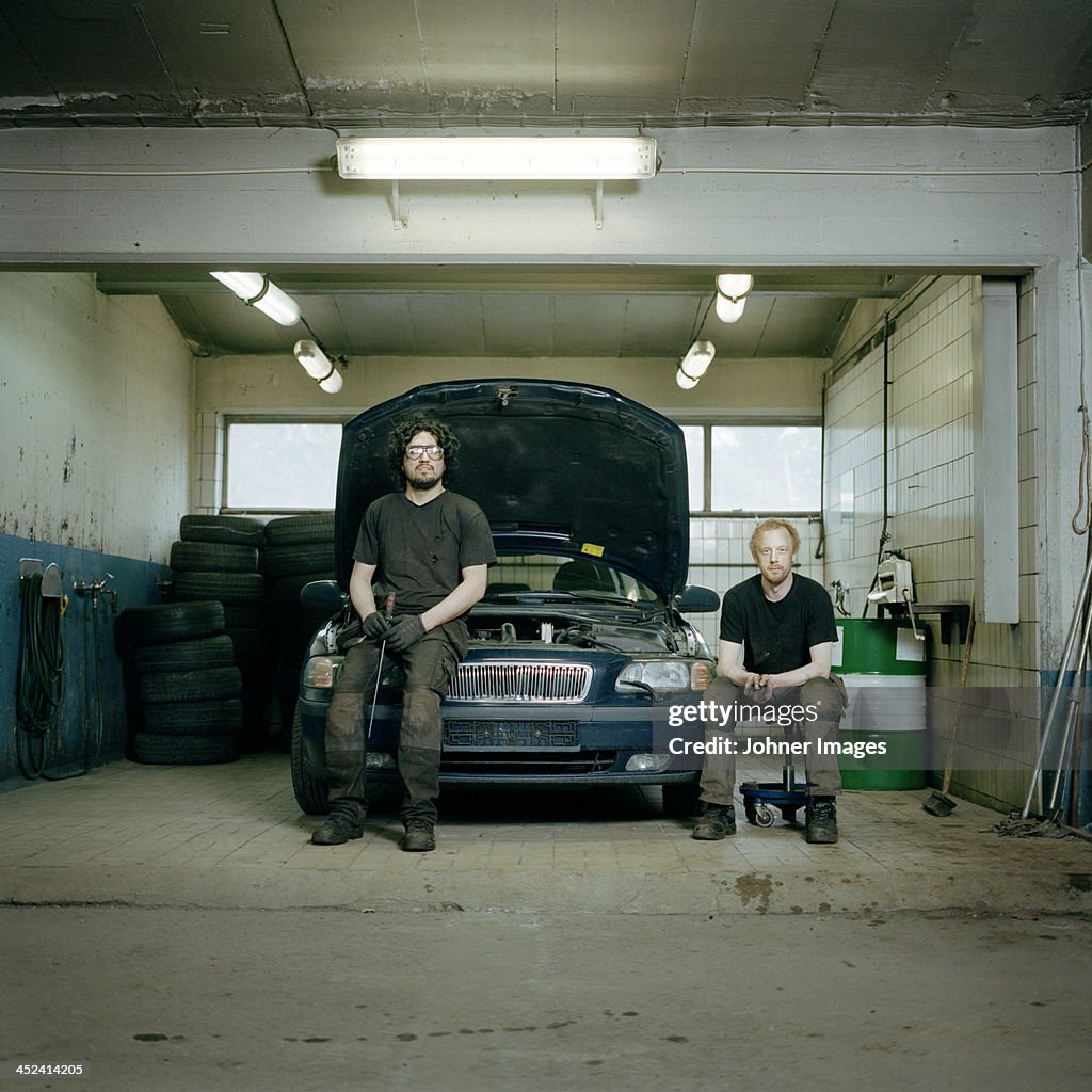 Mechanics in auto repair shop, portrait