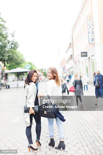 smiling woman walking together, vaxjo, smaland, sweden - vaxjo 個照片及圖片檔