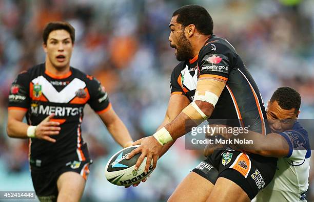 Adam Blair of the Tigers looks to offload during the round 19 NRL match between the Wests Tigers and the Canterbury Bulldogs at ANZ Stadium on July...