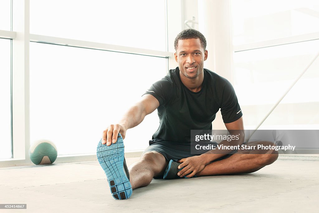 Man sitting touching toes stretching