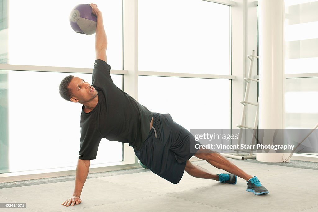 Man stretching using exercise ball