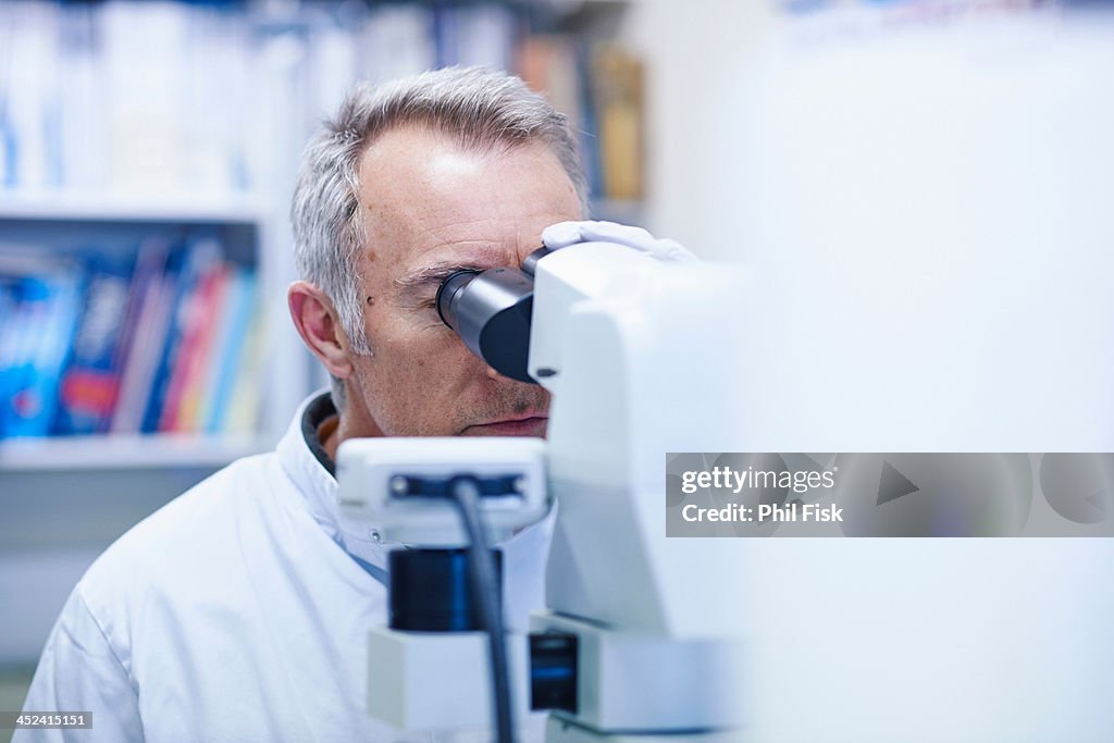 Man looking through microscope