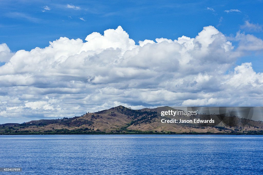 A denuded tropical island cleared for farmland and agriculture.