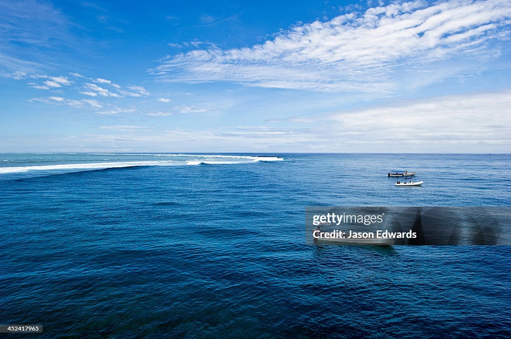 Water taxis wait for surfers at the famous surf reef Cloudbreak.