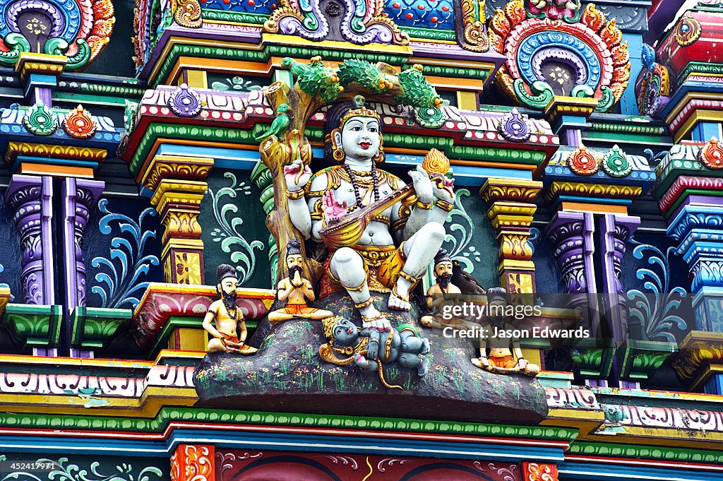 An intricate colorful statue of Shiva at a Hindu temple.