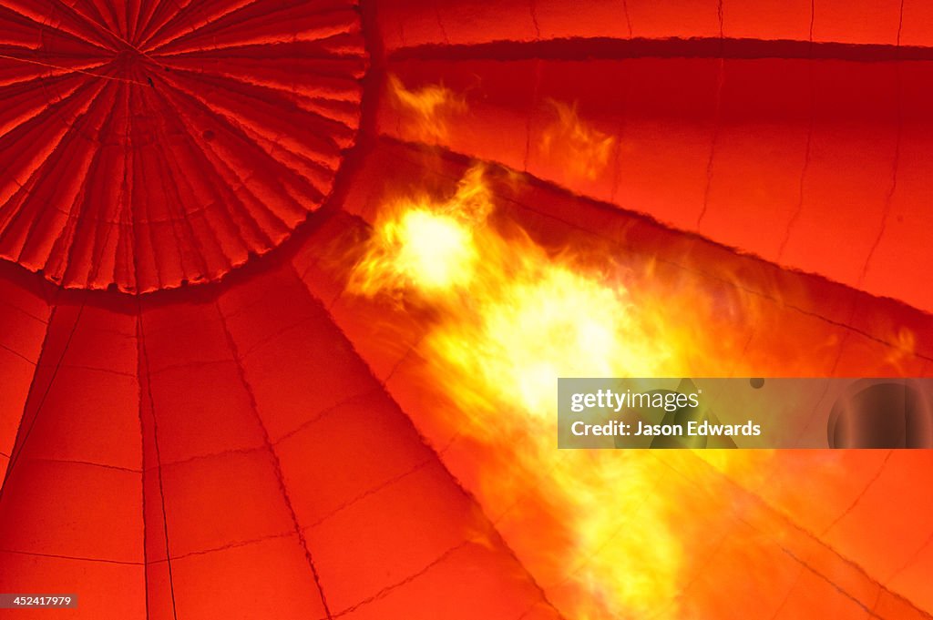 Flame blasts into the canopy of a balloon filling it with hot air.
