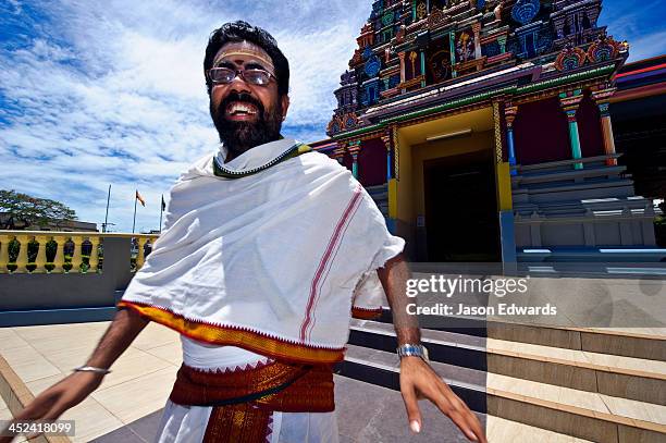 a priest laughing on the steps to a hindu temple during a festival. - fiji smiling stock pictures, royalty-free photos & images