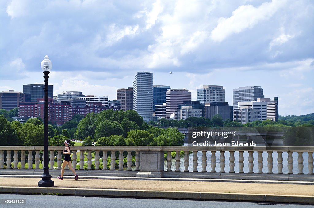 A runner crosses the Arlington Memorial Bridge over the Potomac River.