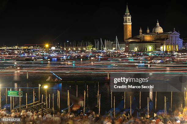 Party goers, gondolas and boats are captured on a long exposure leaving St. Mark's Basin after the fireworks display for the Redentore Celebrations...