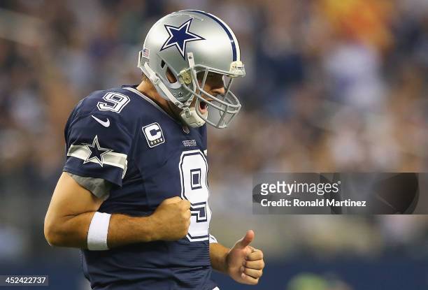Tony Romo of the Dallas Cowboys celebrates a touchdown against the Oakland Raiders at AT&T Stadium on November 28, 2013 in Arlington, Texas.