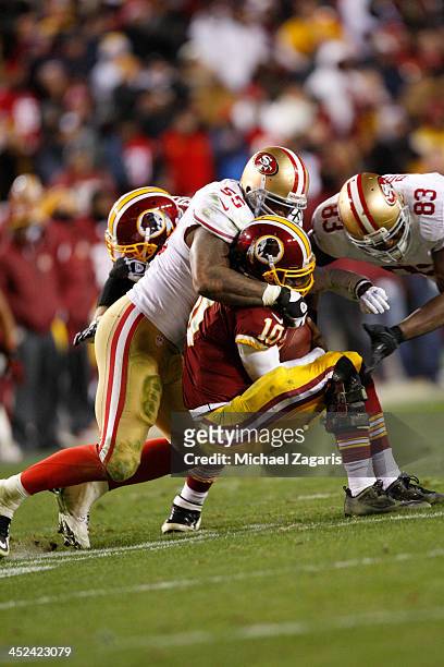 Ahmad Brooks and Demarcus Dobbs of the San Francisco 49ers sacks Robert Griffin III of the Washington Redskins during the game at FedEx Field on...